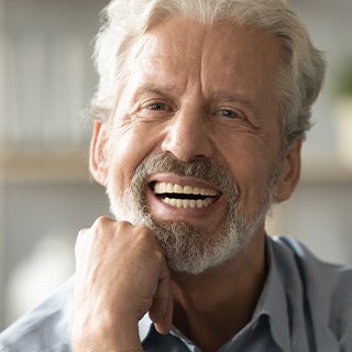 Woman holding full dentures