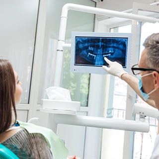 dentist showing a patient their X-rays 