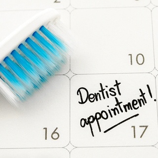 Date of dental appointment on calendar and toothbrush