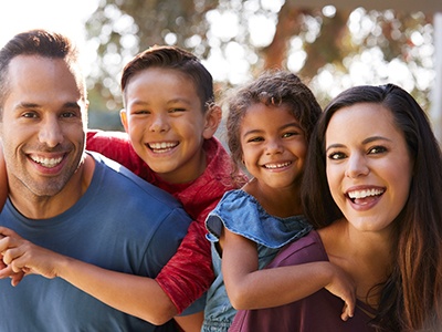 Family smiling together after visiting the dentist