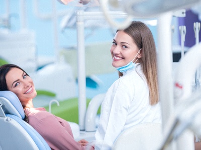 Woman in dental chair with hygienist