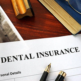 Dental insurance form on clipboard on desk