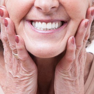 Woman smiling and touching her cheeks
