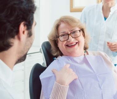 Laughing older woman in dental chair