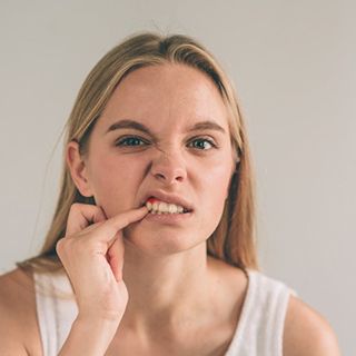 Woman pointing to a tooth that is in pain