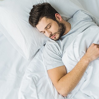 man sleeping after tooth extractions in Pembroke Pines