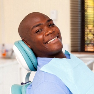 smiling man who has undergone dental implant salvage