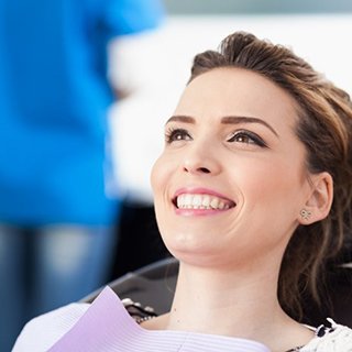 young woman smiling in dental chair