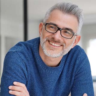 Older man with dental implants in Pembroke Pines smiling