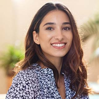 Woman with dental implants in Pembroke Pines smiling outside