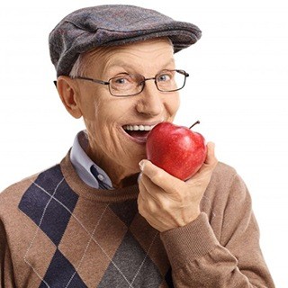 An older man biting into an apple.