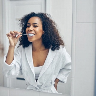 woman brushing her teeth