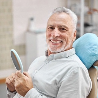smiling senior man in the dental chair
