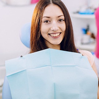 Female dental patient smiling in dentist’s office