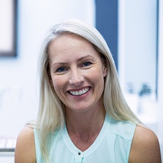 Female dental patient in a light blue shirt