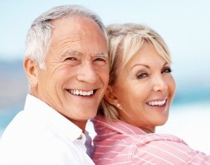 Smiling older man and woman at the beach
