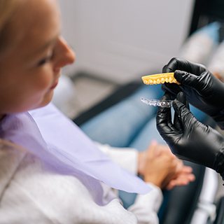 Dentist showing patient how clear aligners work