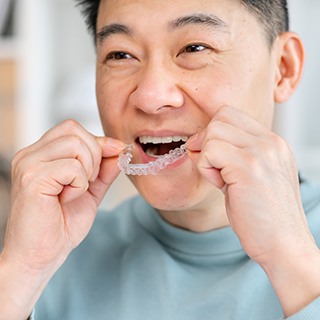 SureSmile patient in Pembroke Pines putting in their aligners