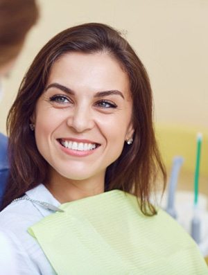 Woman smiling while talking to her dentist