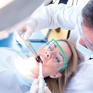 dentist using intraoral camera on female patient