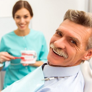 older man smiling in dental chair