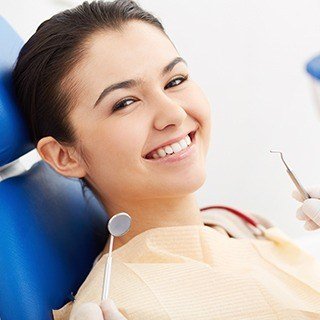 Woman in dental chair smiling