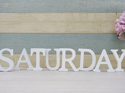 Block letters that spell Saturday on desk