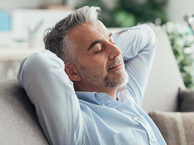 Man relaxing at home after sedation dentistry in Pembroke Pines