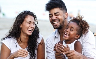 Mother father and child laughing after receiving dental services in Pembroke Pines