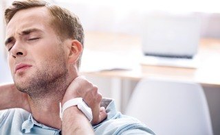 Man in pain holding neck