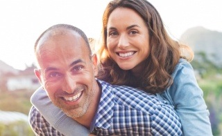 Smiling man and woman outdoors