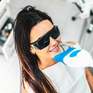 Woman receiving teeth whitening treatment