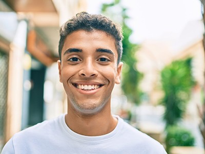 Young man smiling after wisdom tooth extraction in Pembroke Pines