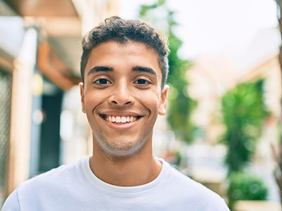 Young man smiling after wisdom tooth extractions in Pembroke Pines