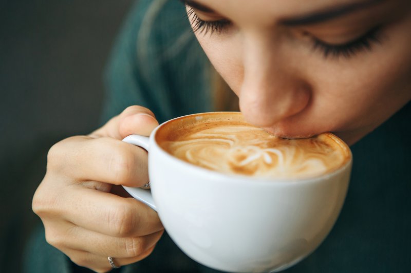 A closeup of a woman drinking coffee