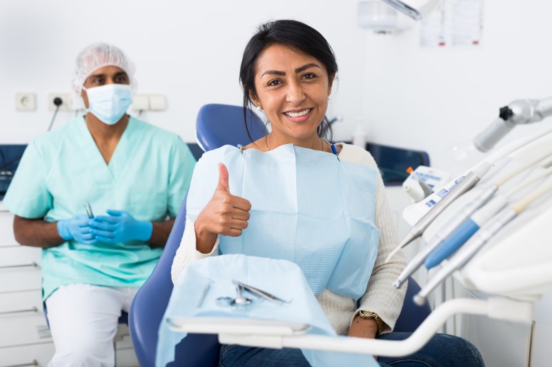 Patient smiling at dentist after root canals